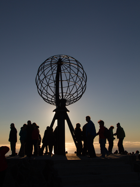 North cape with midsummer sun in the background giving both a nice backklit silhouettepictreu and with the people around it a feeling for the amount of people being there despite being eleven o'clock at night.
