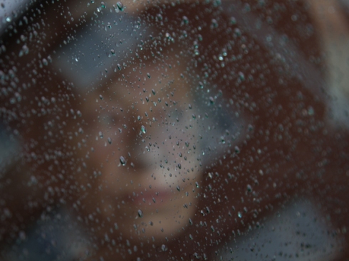 Through a car window with raindrops on it focus on them giving a slightly blurred version of the persons face. In that case my mother who said that she never had a nicer portrait taken of her. And that was the truth she said!