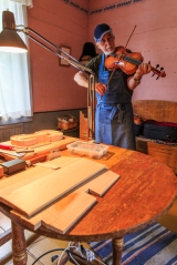 There is even a man building violins, environmental shot